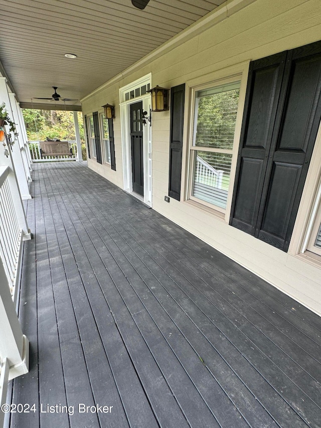 wooden terrace with a porch and ceiling fan