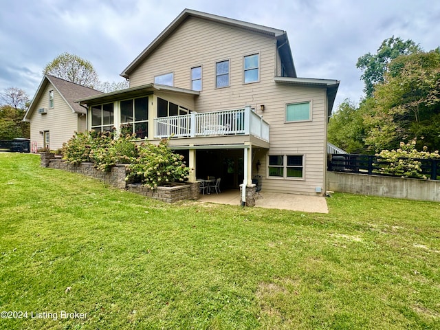 back of property featuring a patio, a sunroom, a wooden deck, and a lawn