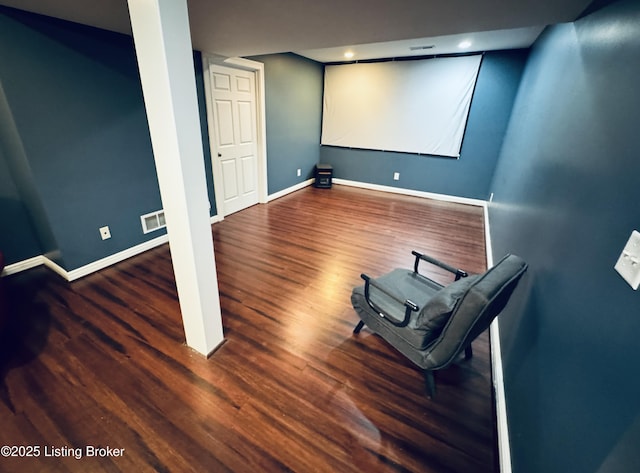 home theater room with dark hardwood / wood-style floors