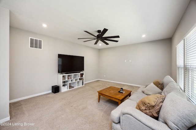 living room featuring ceiling fan and light colored carpet