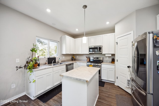 kitchen featuring a center island, dark hardwood / wood-style floors, stainless steel appliances, white cabinets, and hanging light fixtures