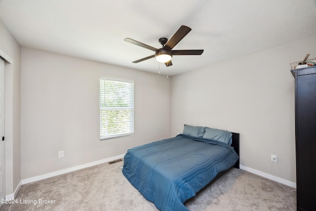 bedroom with light colored carpet and ceiling fan