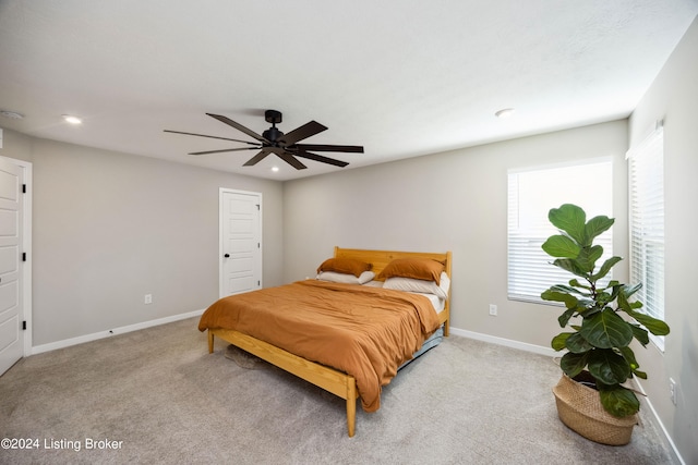 bedroom featuring light carpet and ceiling fan