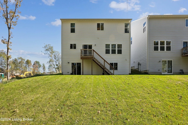 rear view of property featuring a yard