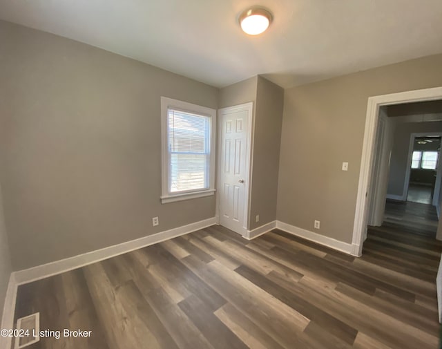 spare room featuring dark hardwood / wood-style flooring