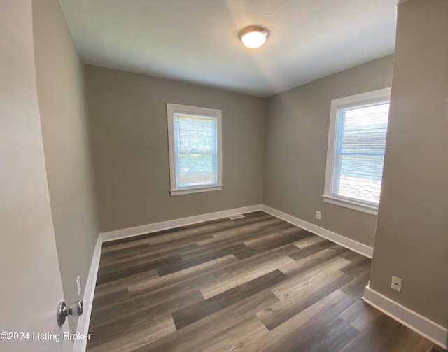 spare room featuring dark hardwood / wood-style flooring