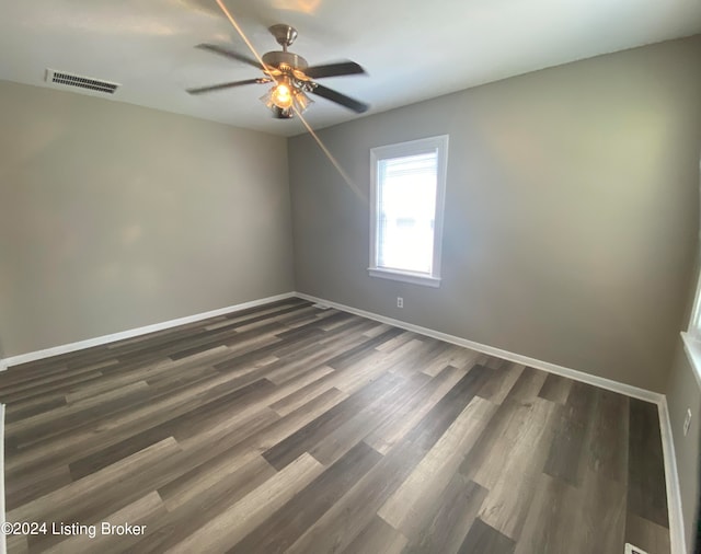 unfurnished room with dark hardwood / wood-style flooring and ceiling fan