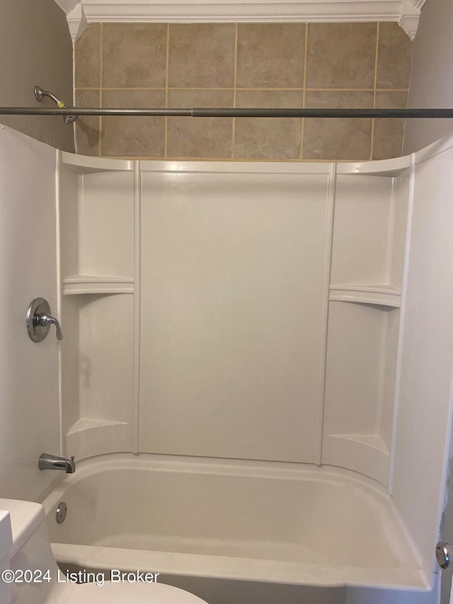 bathroom with crown molding, toilet, and shower / bathtub combination