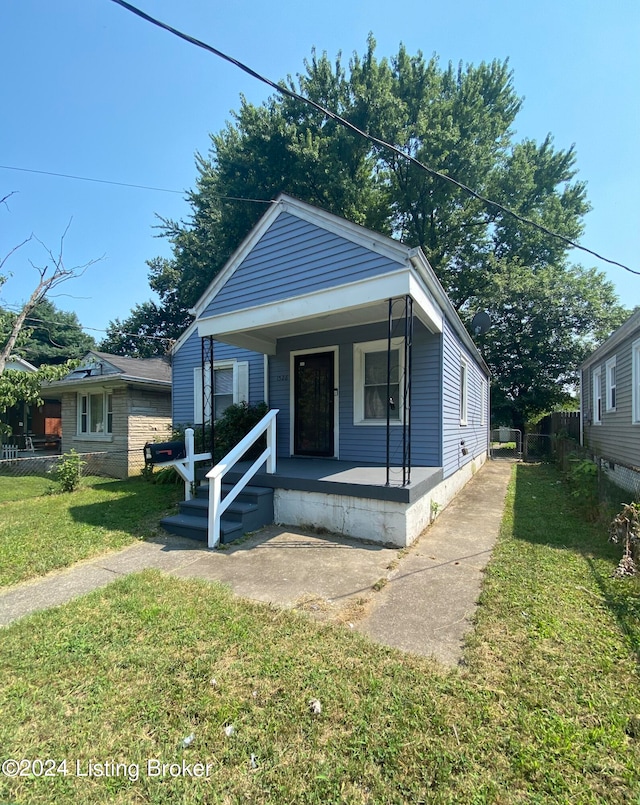 bungalow-style house with a front lawn and a porch