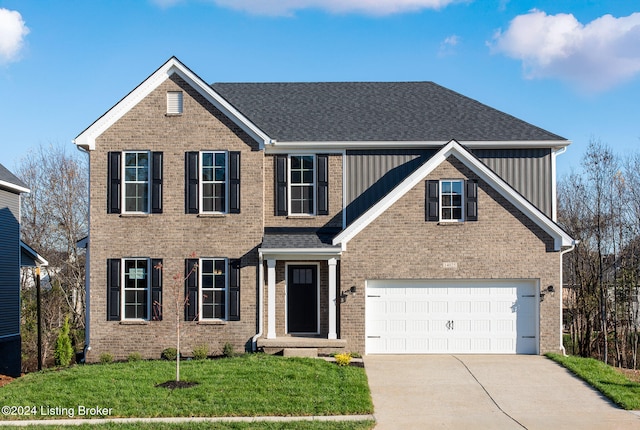 view of front of house with a garage and a front lawn