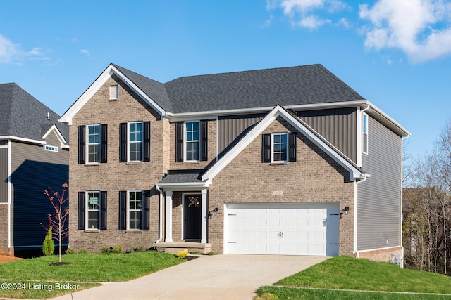 view of front of property with a garage and a front lawn