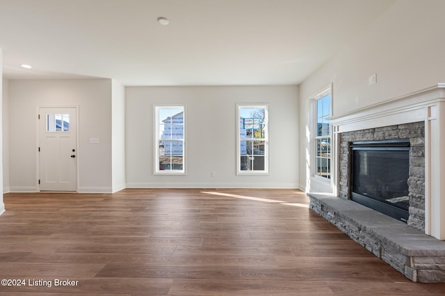 unfurnished living room featuring a fireplace and wood-type flooring