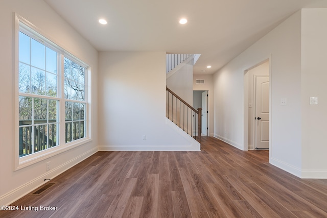 spare room with dark hardwood / wood-style flooring