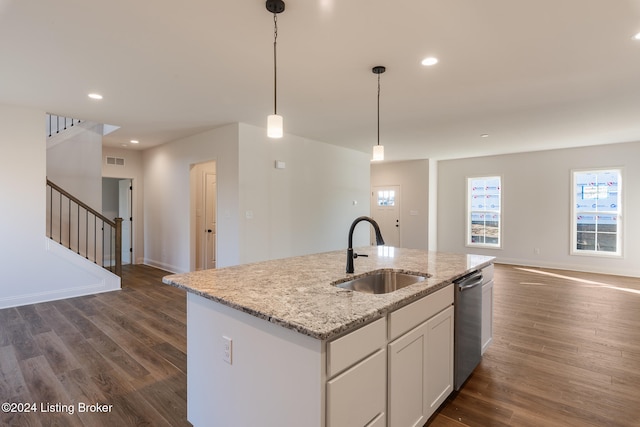 kitchen featuring a center island with sink, white cabinetry, decorative light fixtures, dark hardwood / wood-style floors, and sink