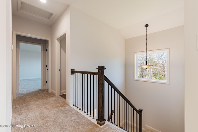 staircase with carpet flooring and lofted ceiling