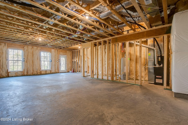 basement featuring gas water heater and heating unit