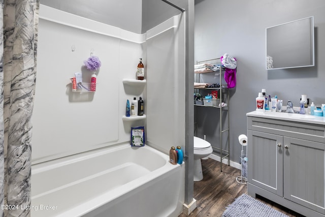 full bathroom featuring shower / tub combo with curtain, wood-type flooring, toilet, and vanity