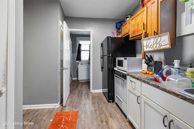 kitchen featuring white cabinetry, white appliances, and light hardwood / wood-style floors