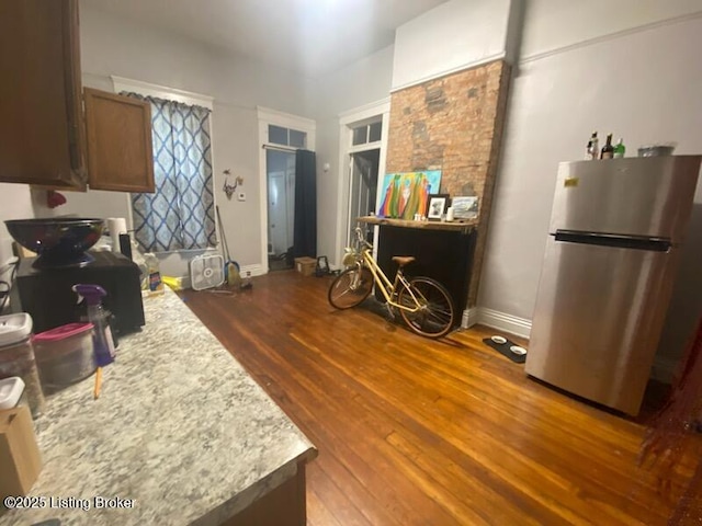 kitchen with stainless steel refrigerator and hardwood / wood-style flooring