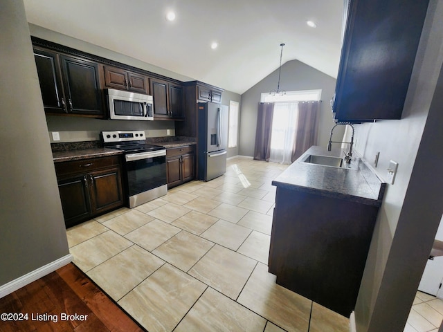 kitchen with dark brown cabinetry, stainless steel appliances, sink, vaulted ceiling, and light hardwood / wood-style flooring