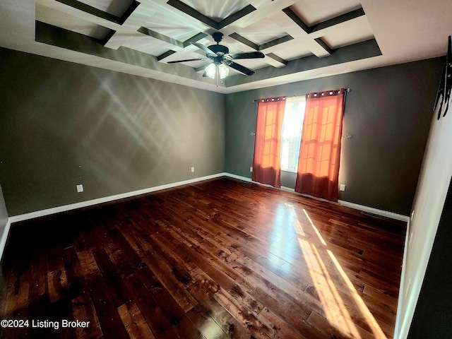 empty room featuring coffered ceiling, hardwood / wood-style flooring, beam ceiling, and ceiling fan