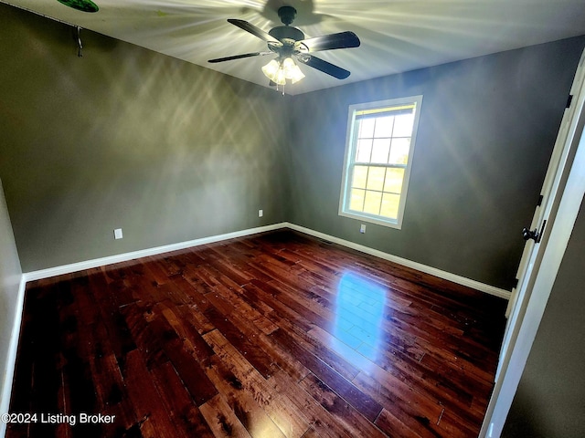 spare room with hardwood / wood-style floors and ceiling fan