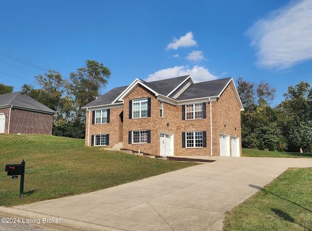 view of front of house with a front yard and a garage