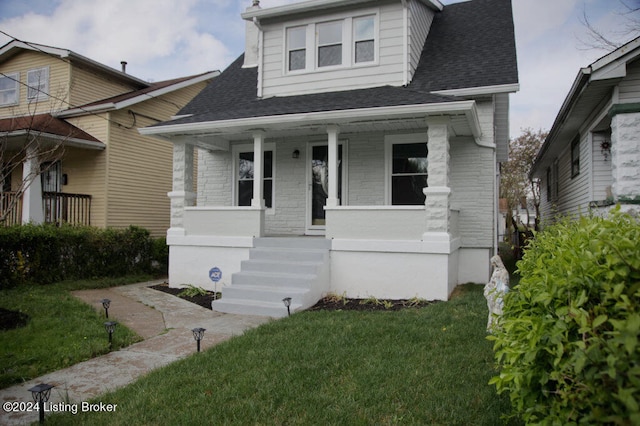 bungalow-style home with a front yard and a porch