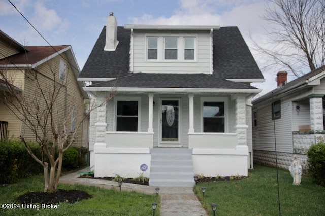 bungalow-style house featuring a front lawn