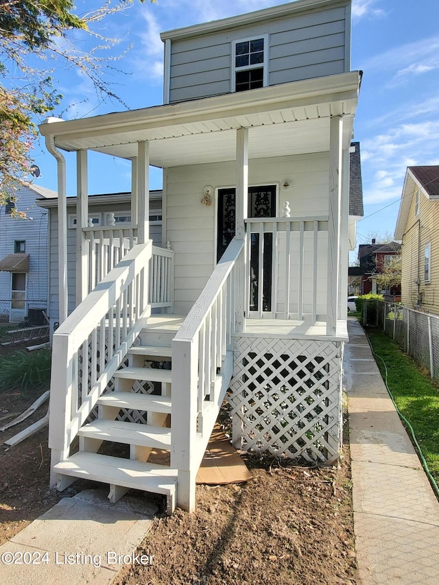 view of exterior entry with covered porch