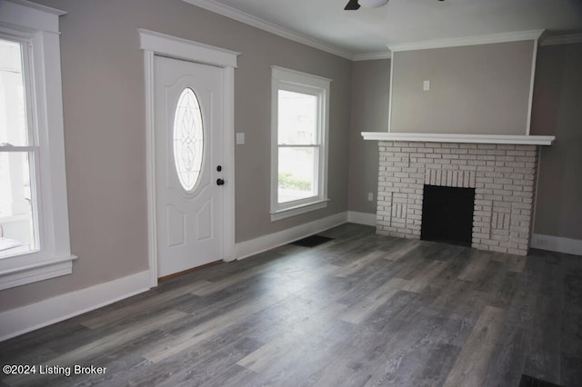 foyer entrance with crown molding, ceiling fan, a fireplace, and dark hardwood / wood-style floors