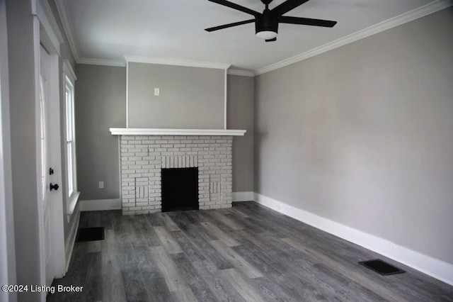 unfurnished living room featuring ceiling fan, a fireplace, dark hardwood / wood-style floors, and crown molding