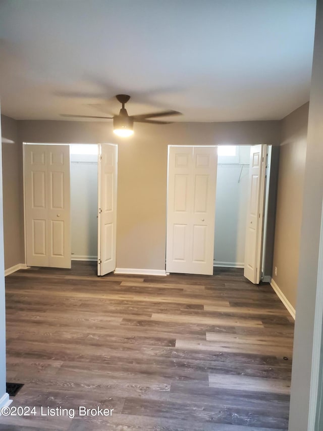 unfurnished bedroom featuring dark hardwood / wood-style flooring and ceiling fan