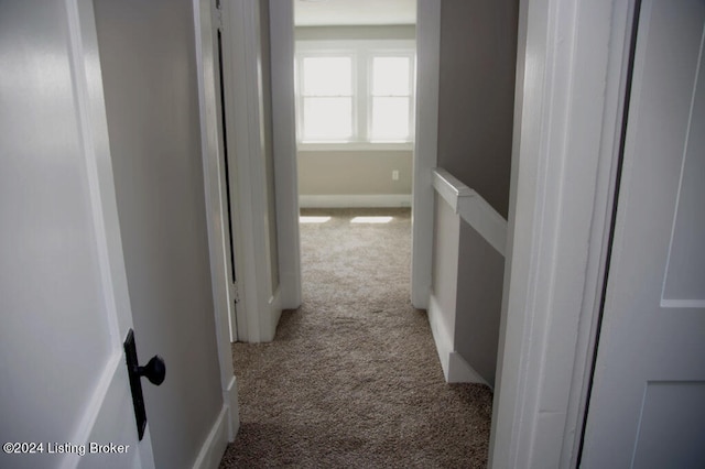 hall with light colored carpet