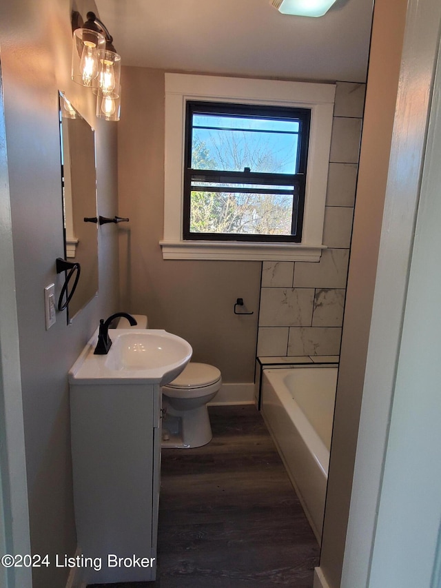 full bathroom featuring shower with separate bathtub, hardwood / wood-style floors, vanity, and toilet