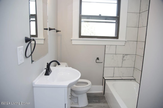 full bathroom with wood-type flooring, vanity, bathing tub / shower combination, and toilet