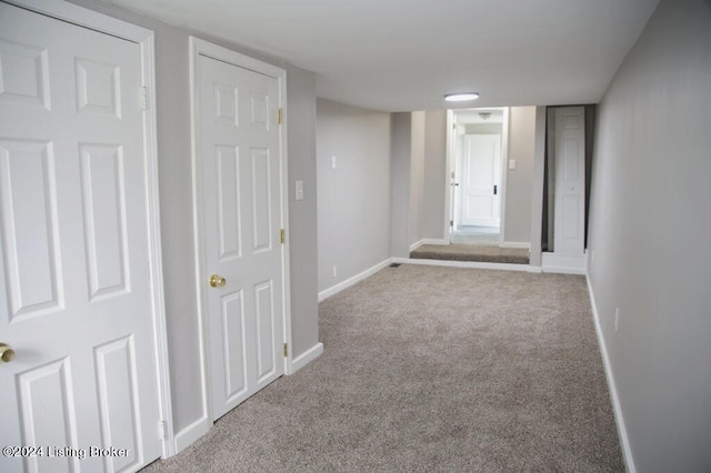 hallway with light colored carpet