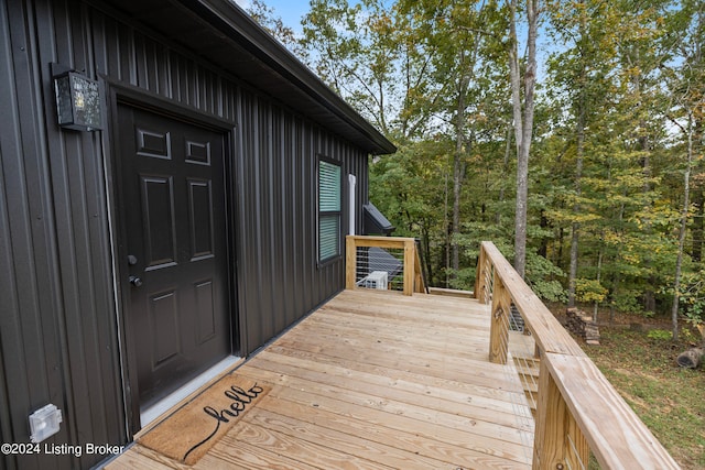 view of exterior entry featuring a deck