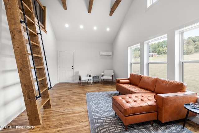 living room with beam ceiling, high vaulted ceiling, a wall mounted air conditioner, and hardwood / wood-style floors