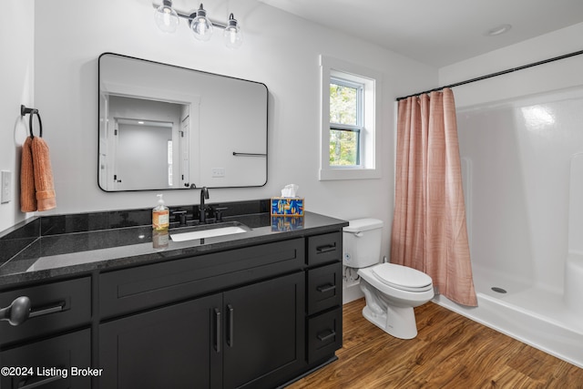 bathroom with vanity, toilet, hardwood / wood-style flooring, and a shower with curtain