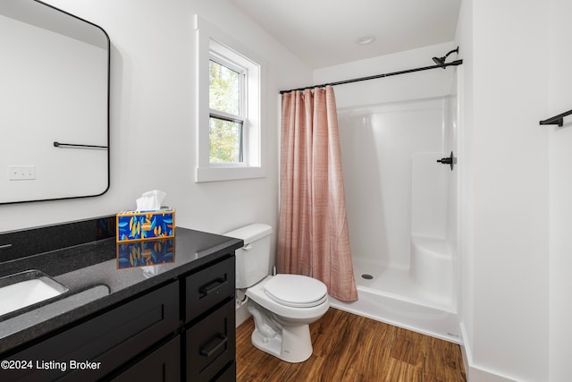 bathroom with vanity, toilet, a shower with shower curtain, and hardwood / wood-style floors