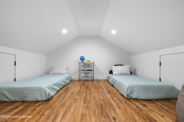 bedroom featuring lofted ceiling and hardwood / wood-style floors