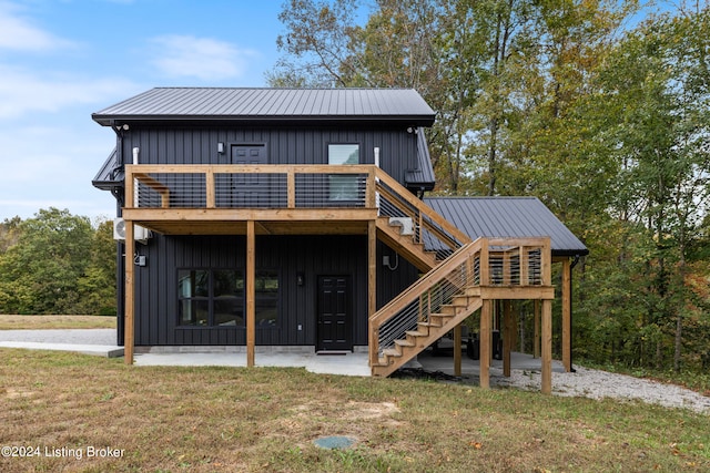 back of house with a patio, a deck, and a lawn