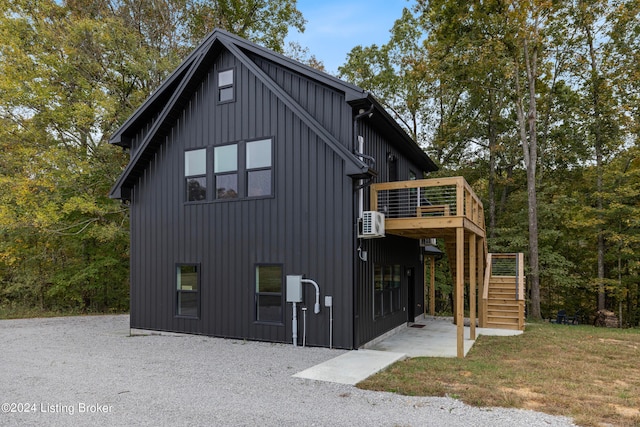 view of side of property featuring a wooden deck