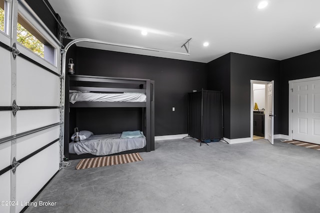 unfurnished bedroom featuring connected bathroom and concrete flooring