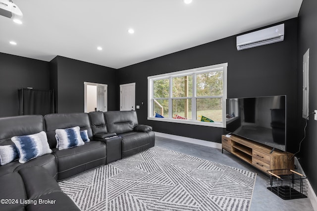 home theater featuring concrete flooring and a wall mounted air conditioner