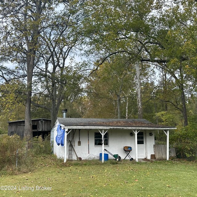 view of outdoor structure featuring a lawn