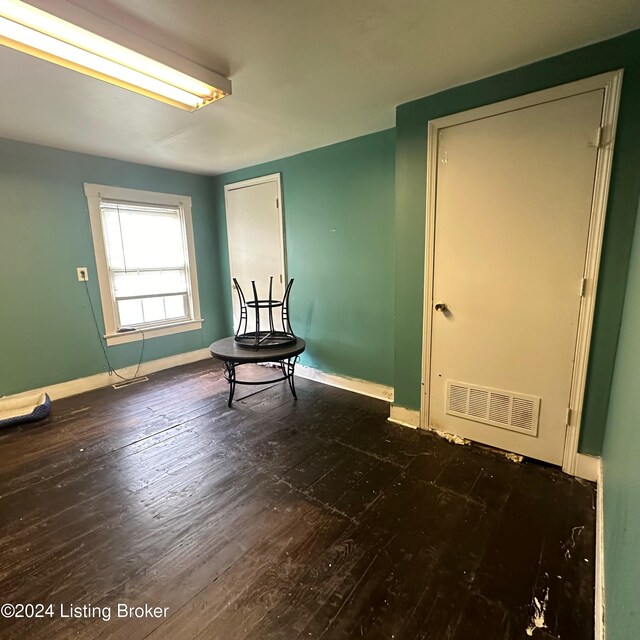 spare room with dark wood-type flooring