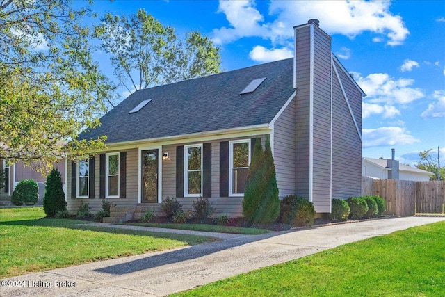 cape cod home featuring a front lawn