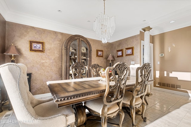 tiled dining area featuring ornamental molding, a chandelier, and ornate columns